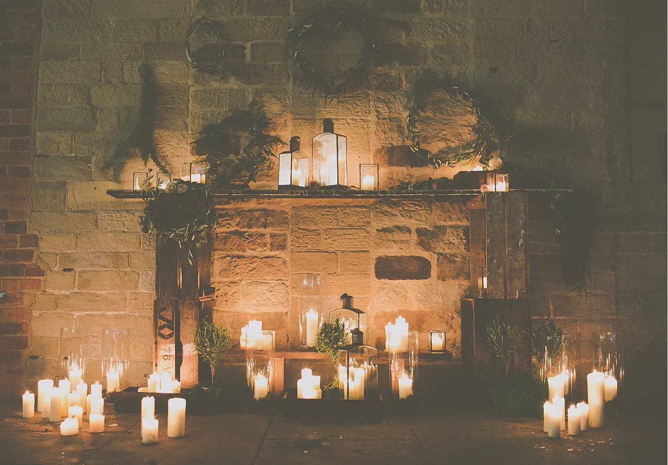 Candles glowing against a Yorkshire stone wall at The Arches