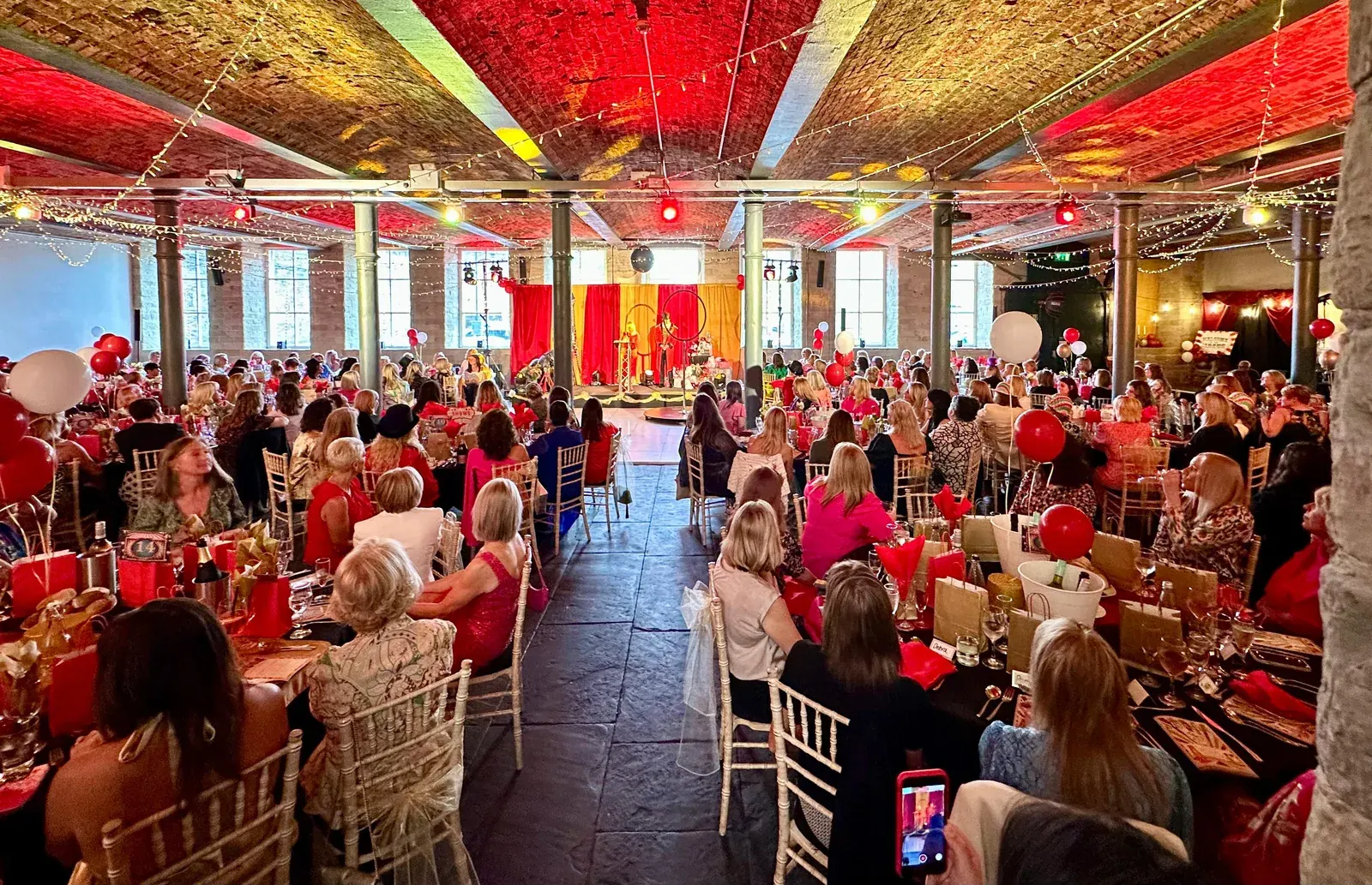 A charity ball in full swing at The Arches, the room dressed in red