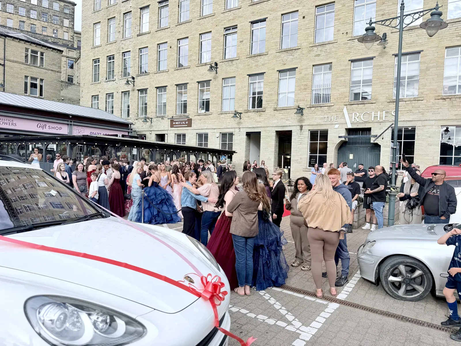 Guests arriving by sports car for a prom at Dean Clough